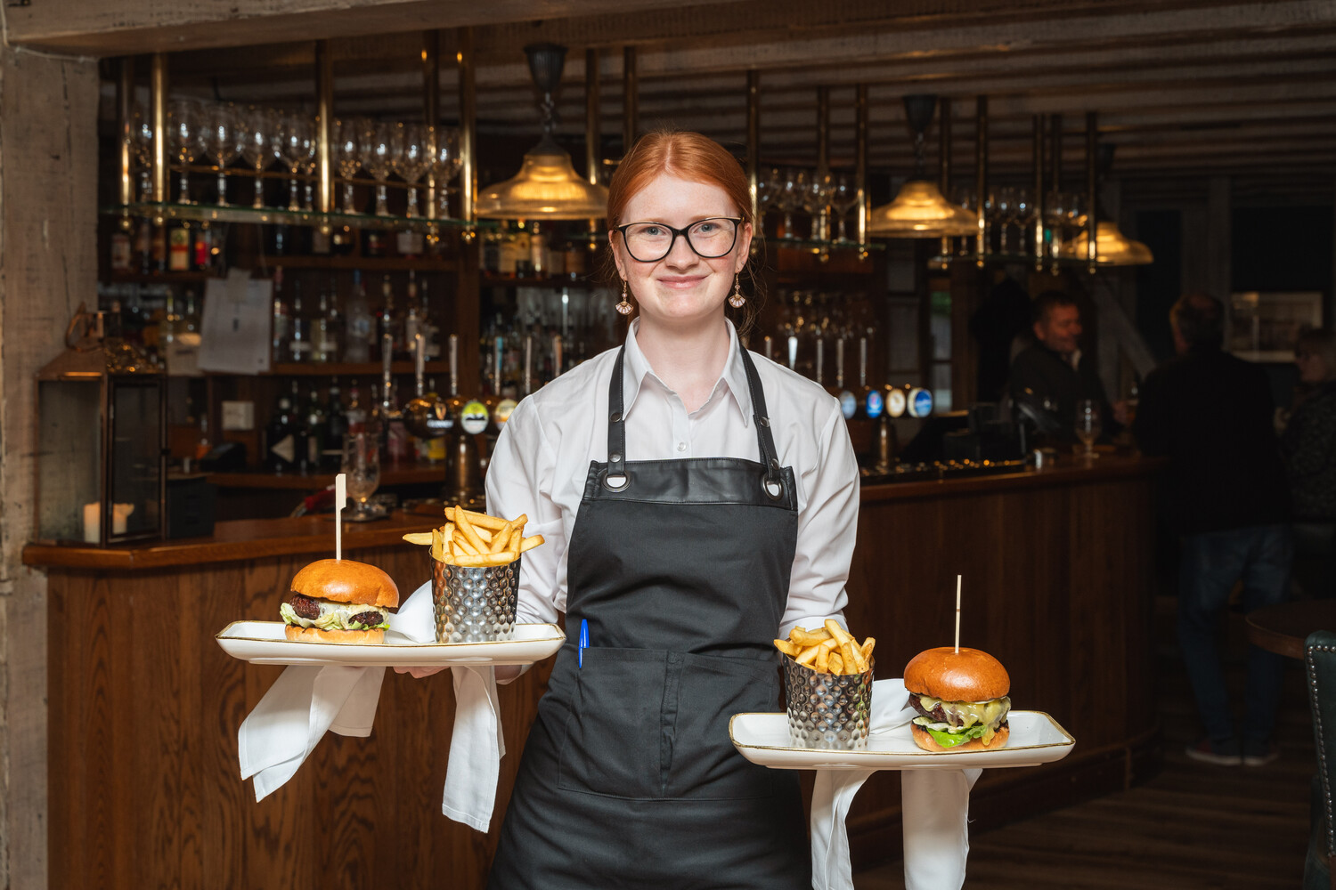 Team member at the Bellhouse Pub in Essex serving food