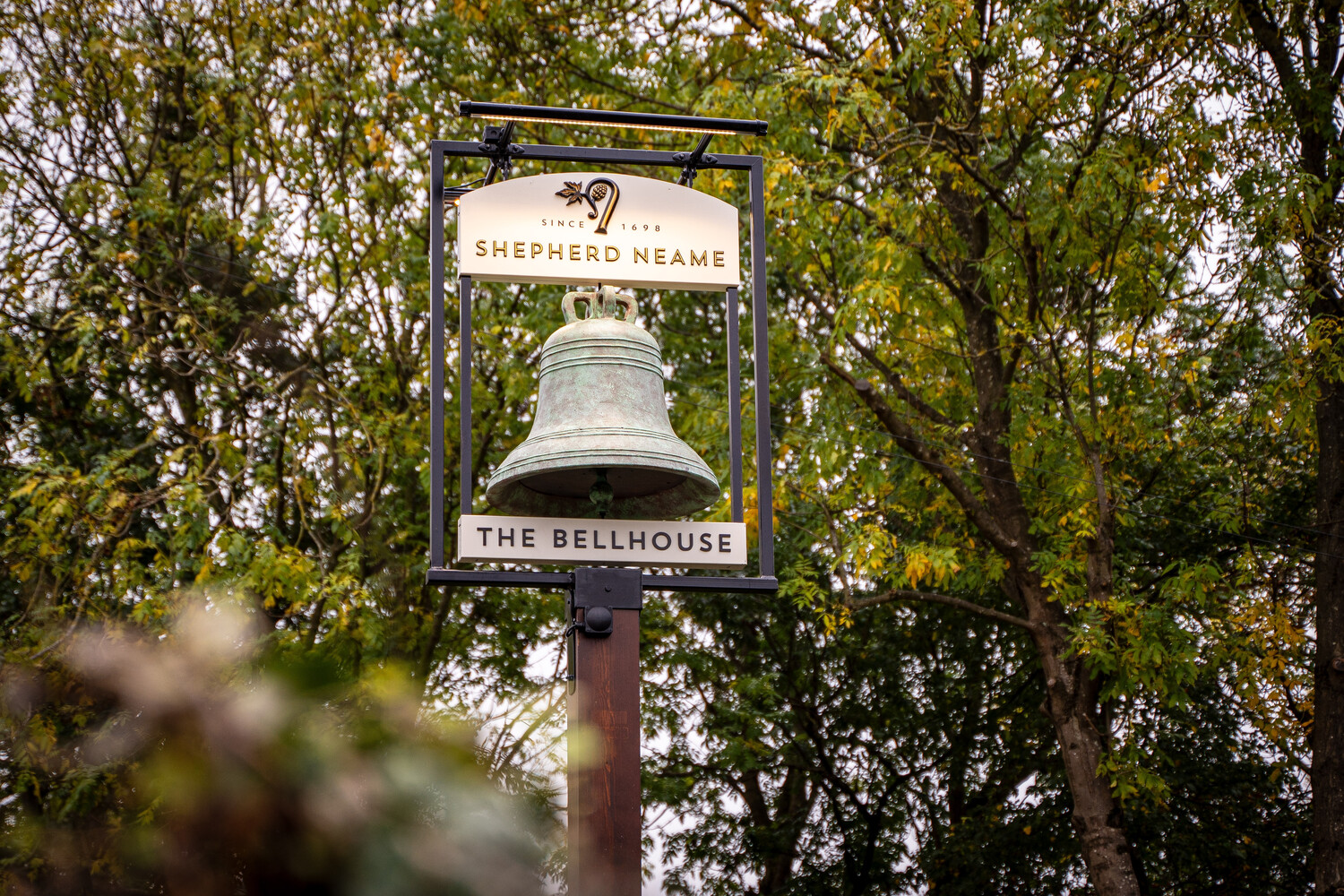 Bellhouse Pub in Essex, image of swing sign with a bell