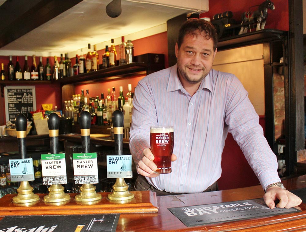 Nick Steinmetz behind the bar at The White Lion Selling