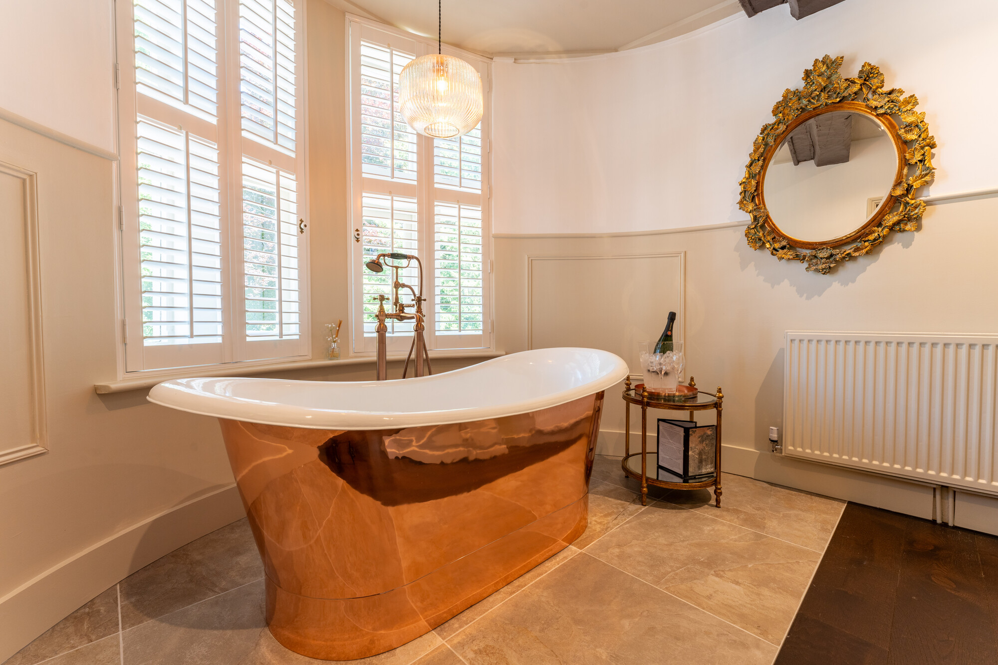 A copper rolltop bath features in the Taittinger Suite